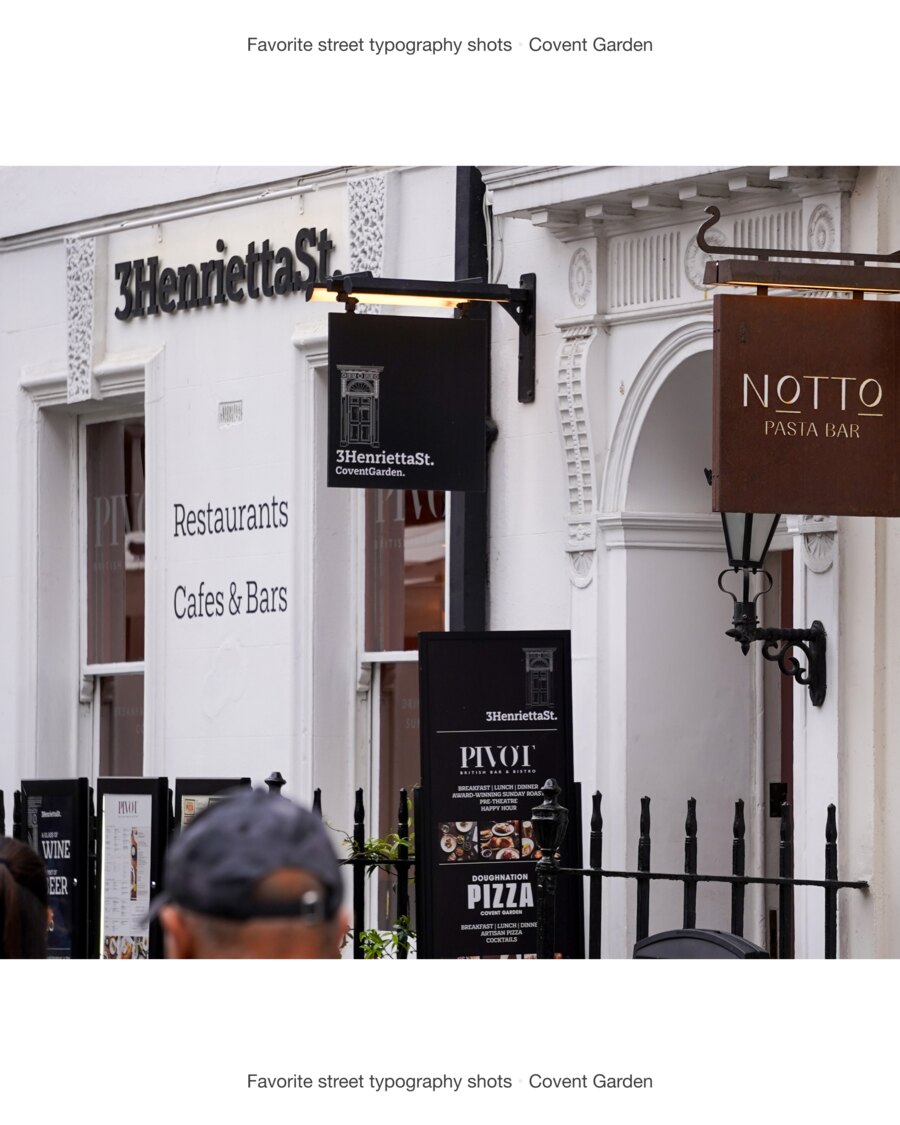3HenriettaSt. spelled in black letters across white render, a hanging sign repeating it over a drawing of a doorway, a rusted Notto Pasta Bar sign, and an A-board for Pivot listing breakfast, lunch and dinner.